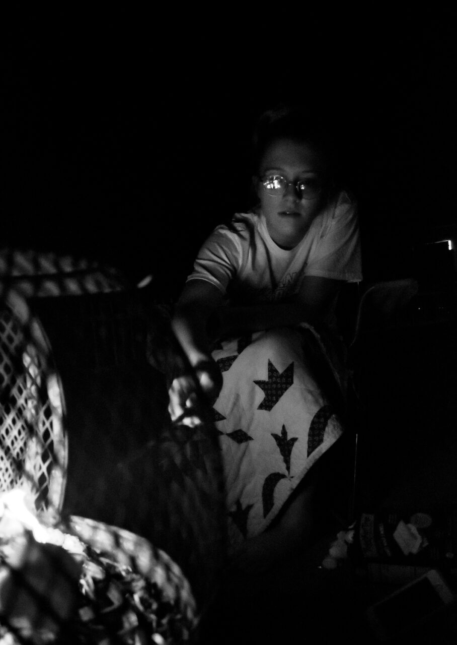 Alivia Jade Fann roasts a marshmallow in the fire during family time.