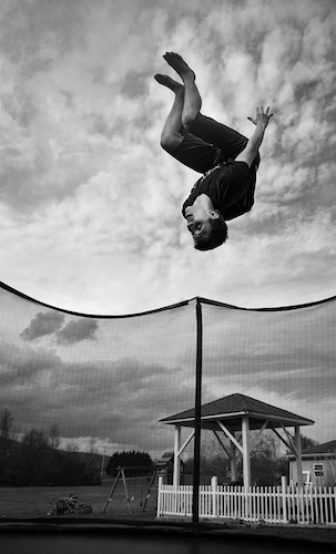 Rian Scott Fann tucks on the trampoline during a flipping contest with his sister.