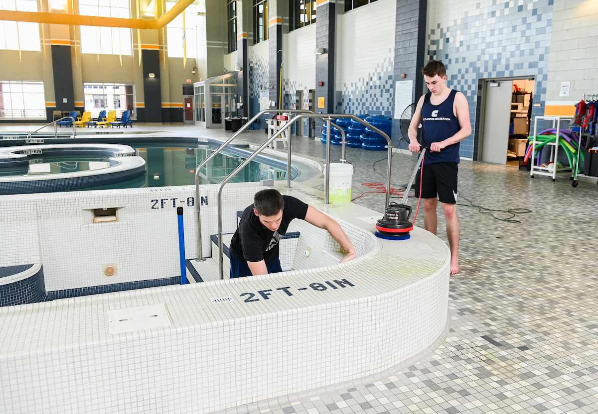 With the Aquatic and Recreation Center closed, workers from a local company clean and disinfect the pool on March 19, 2020.