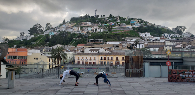 Yoga stretches in Quito, Ecuador with the Virgin del Panecillo—the silver angel—in the background.