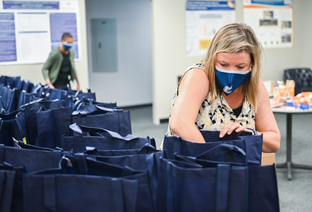 Jill Shelton, associate professor of psychology, packs a bag that's going to the Summit View Senior Community.