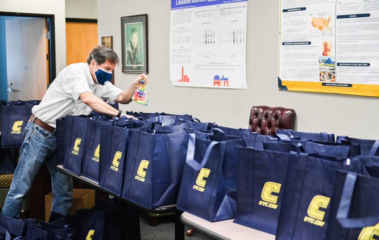 Brian O'Leary, head of the Department of Psychology, helps pack the bags.