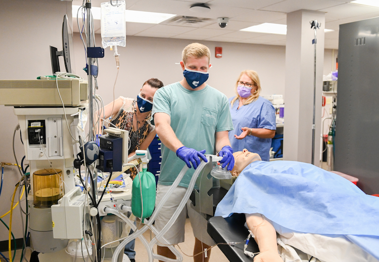 Nurse anesthesia students will have to wear masks when they're working in hospitals but they're wearing them in labs, too.