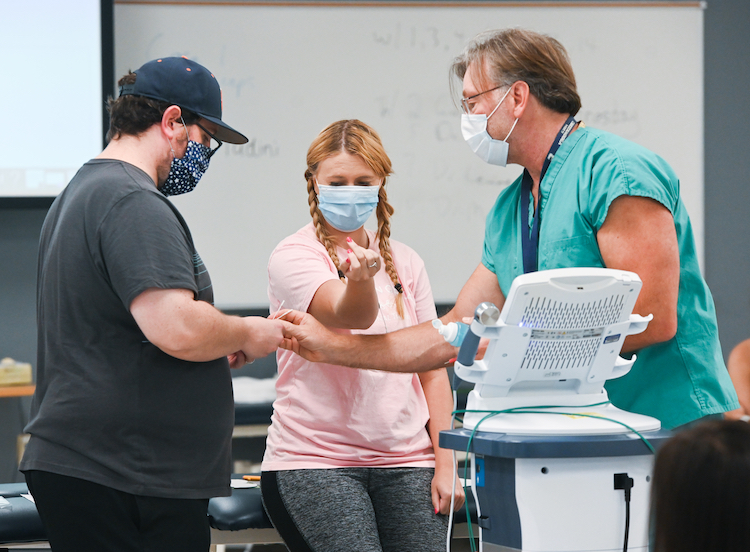 Occupational therapy students learn to treat patients while wearing masks.