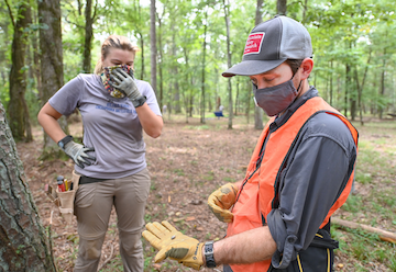 Assistant Professor Morgan Smith examines a Minie ball found during the dig.