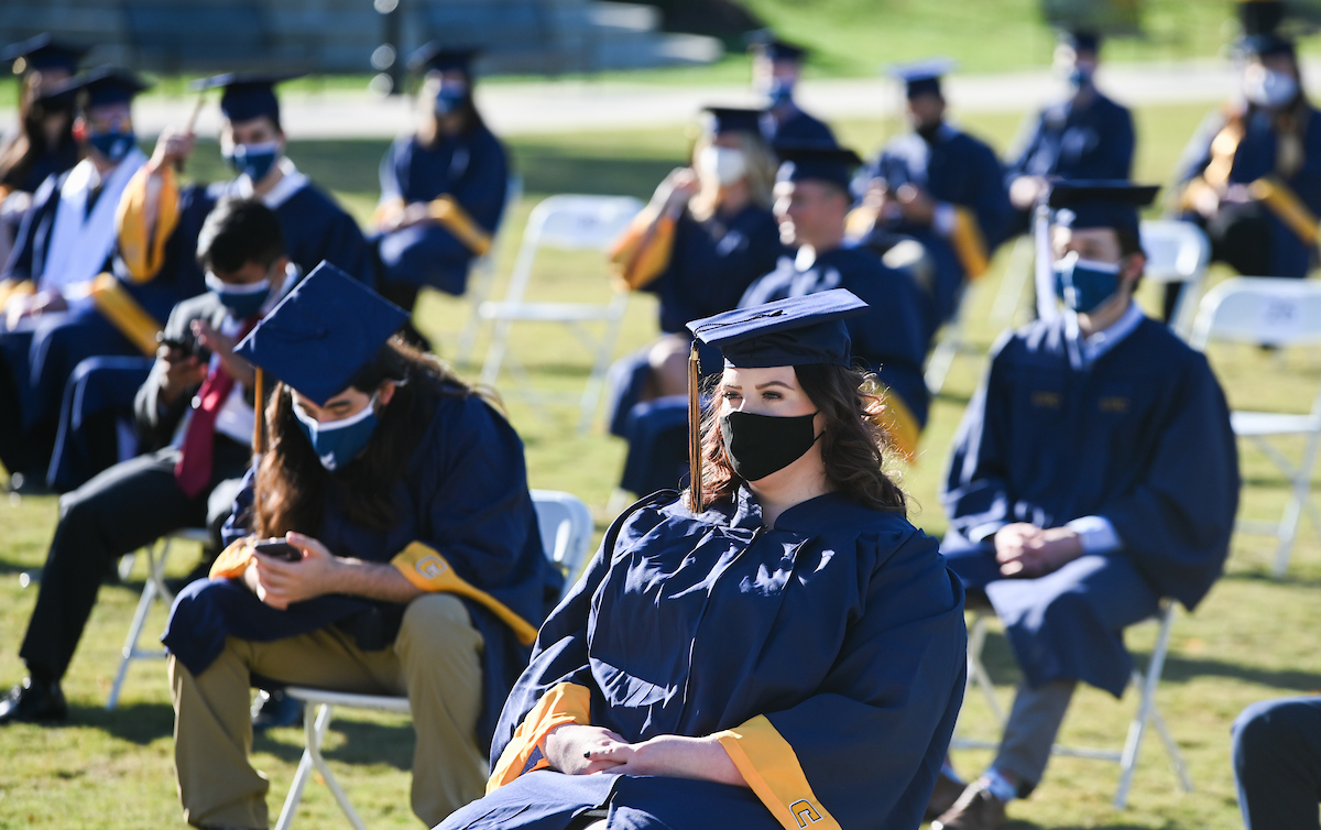 Undergraduate students participate in a commencement ceremony Thursday, Nov. 19, 2020 on Chamberlain Field.
