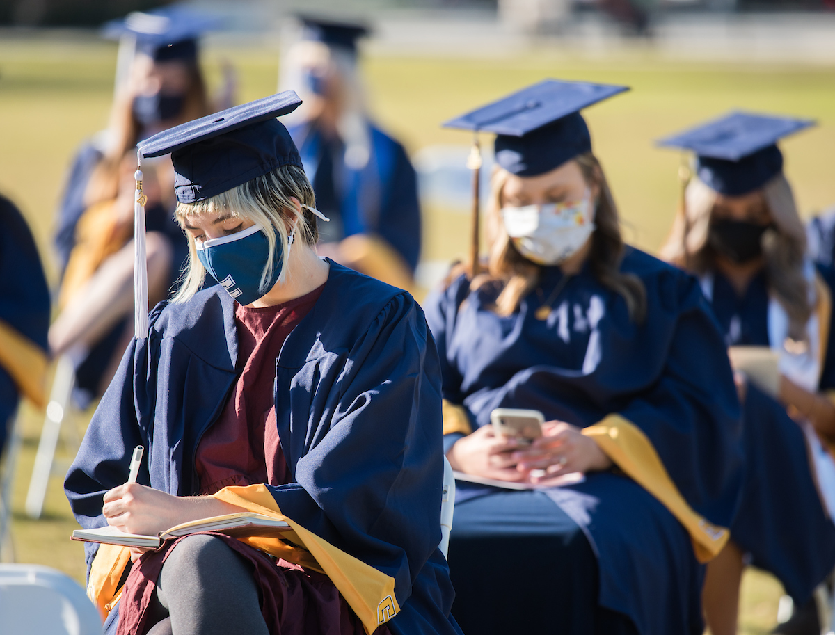 Undergraduate students participate in a commencement ceremony on Friday, Nov. 20, 2020 on Chamberlain Field.