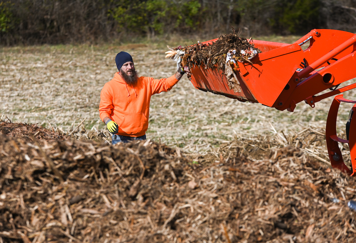Michael Ryan waits for a load of new compost to be dumped on existing pile.