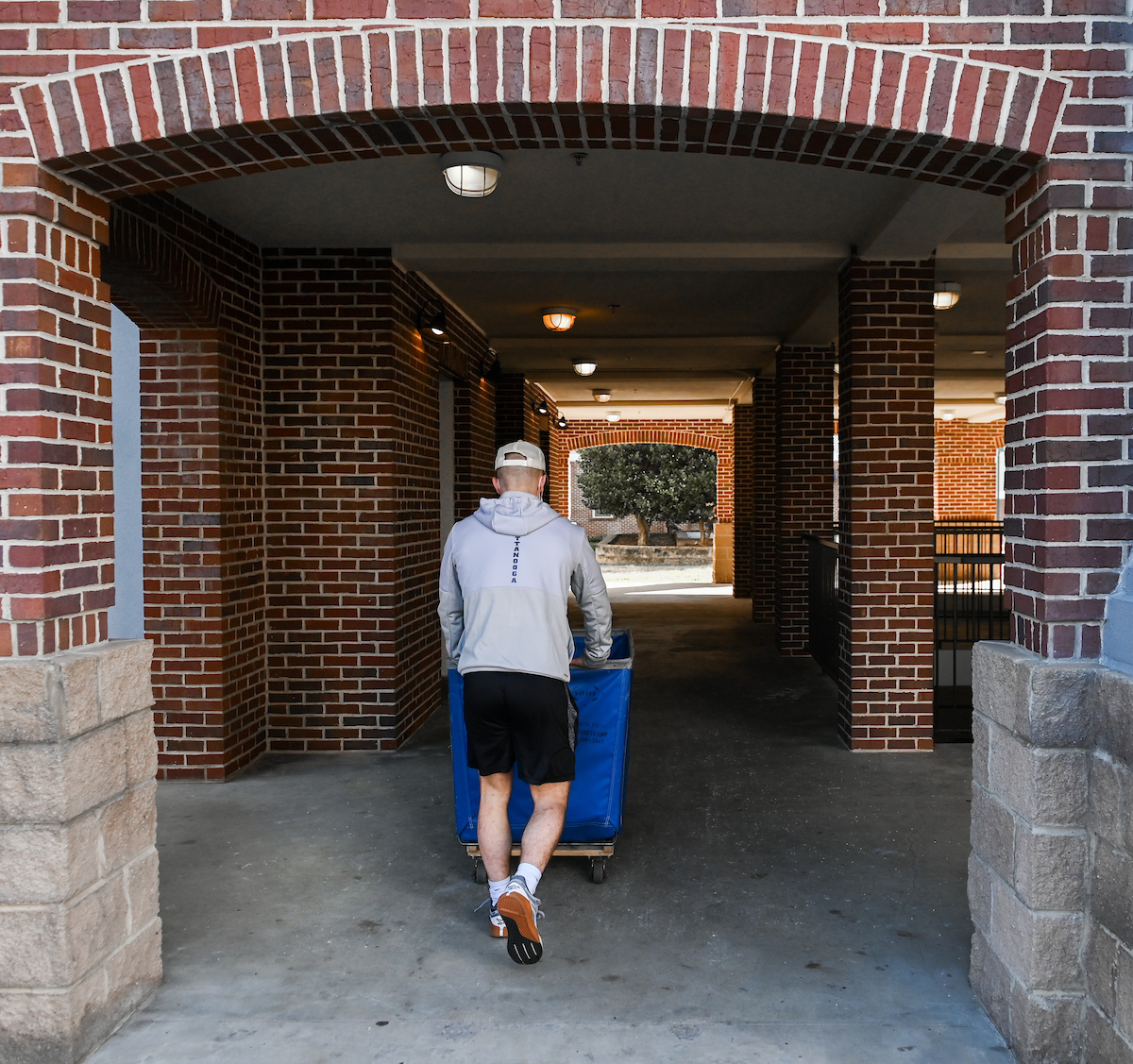 Matthew Williams, a member of the Mocs wrestling team, pushes his belongings to his room in UC Foundation Apartments.