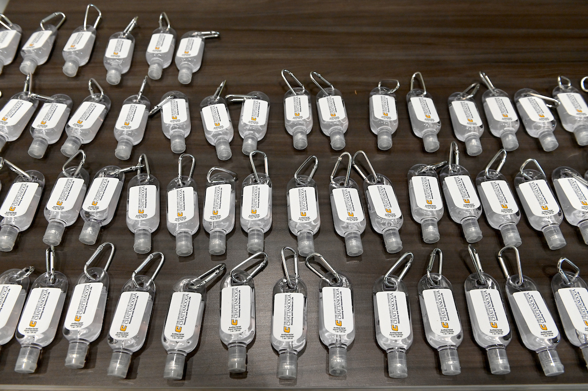 Key rings with antibacterial gel are offered on a table in West Campus housing.