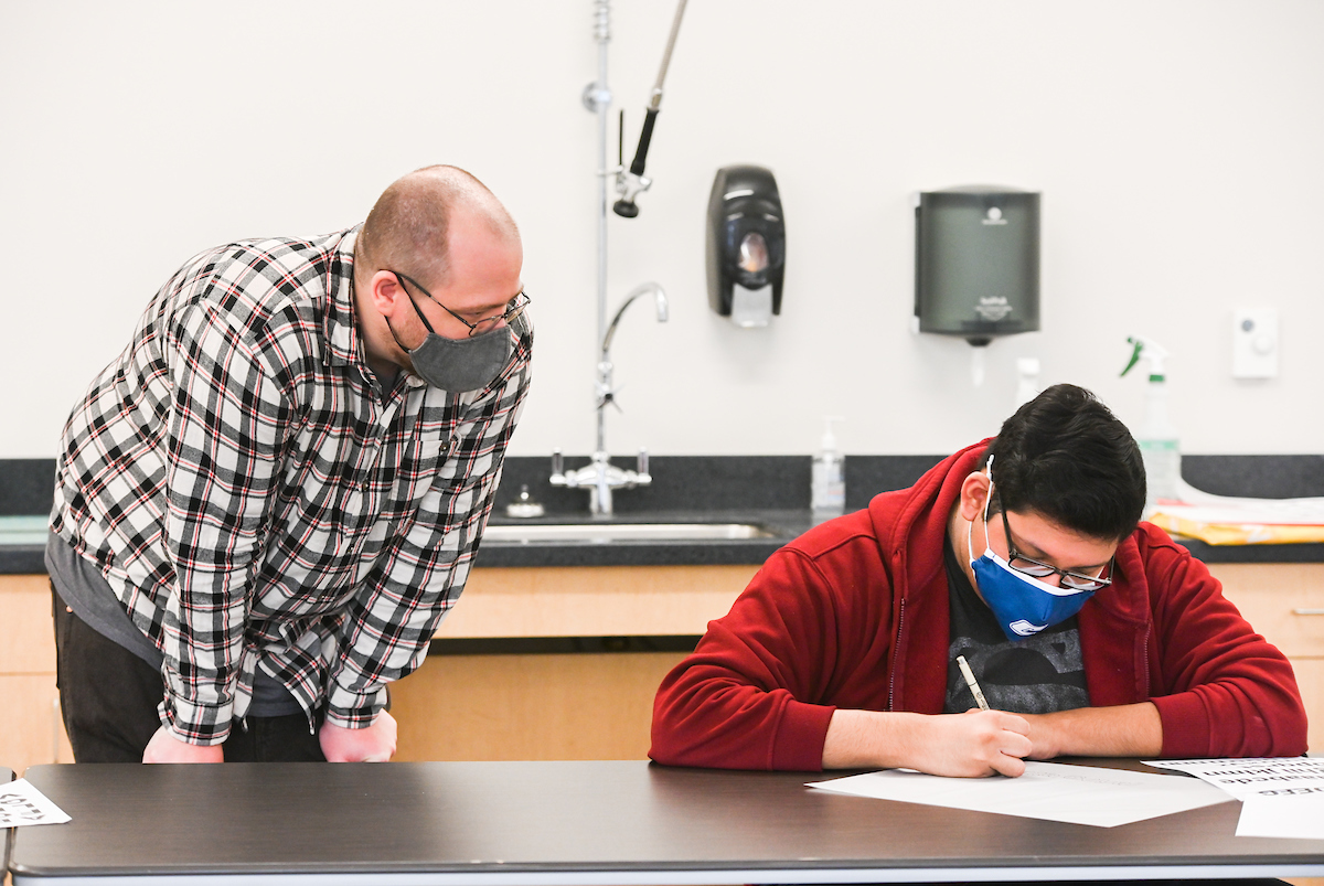 Professor Derek Witucki helps a student in his Typography class.