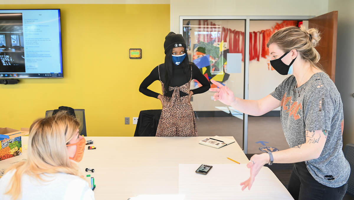 Kate Greenwell, from left, Delali Gadzekpo and Sawyer Suerth discuss the assignment.