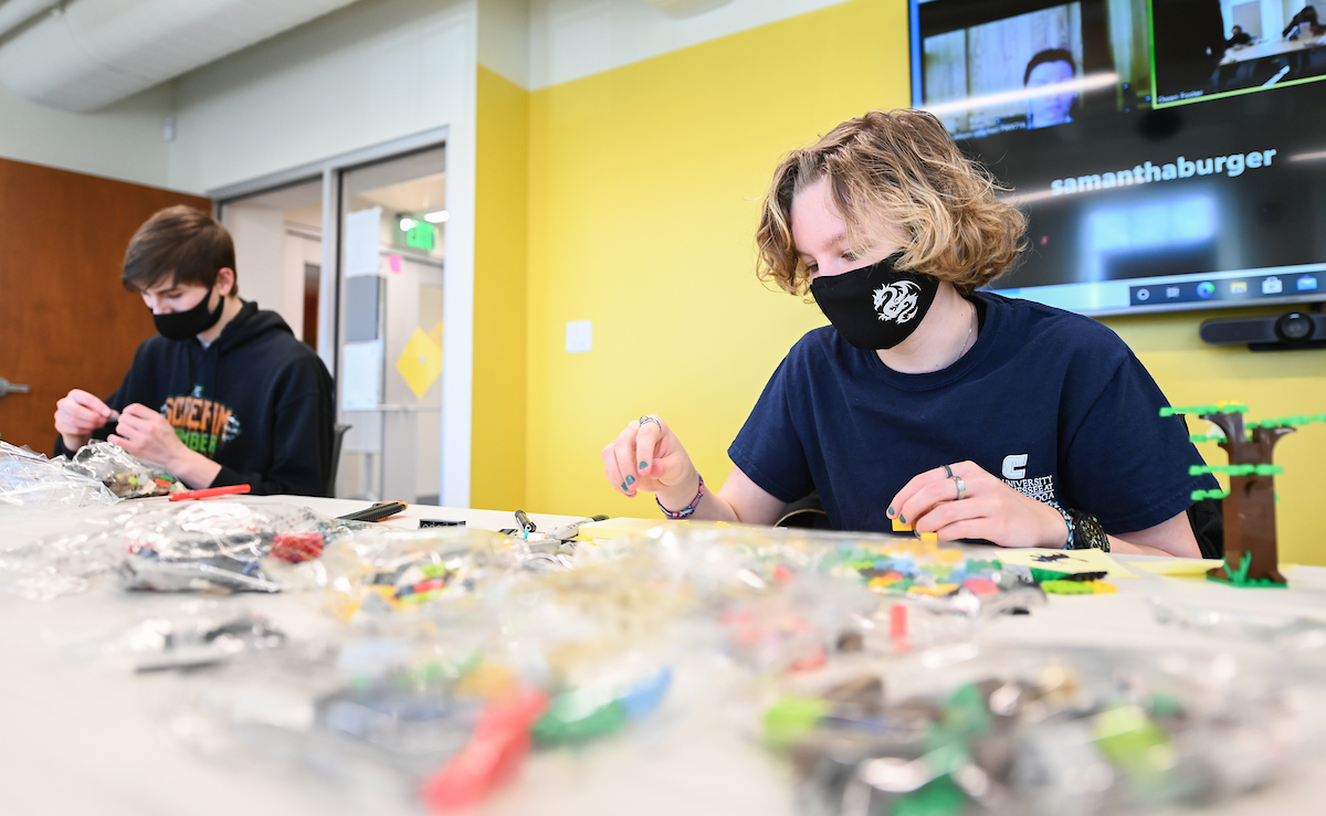 Jaden Partain and Jaz Holcomb sift through building blocks during the assignment.