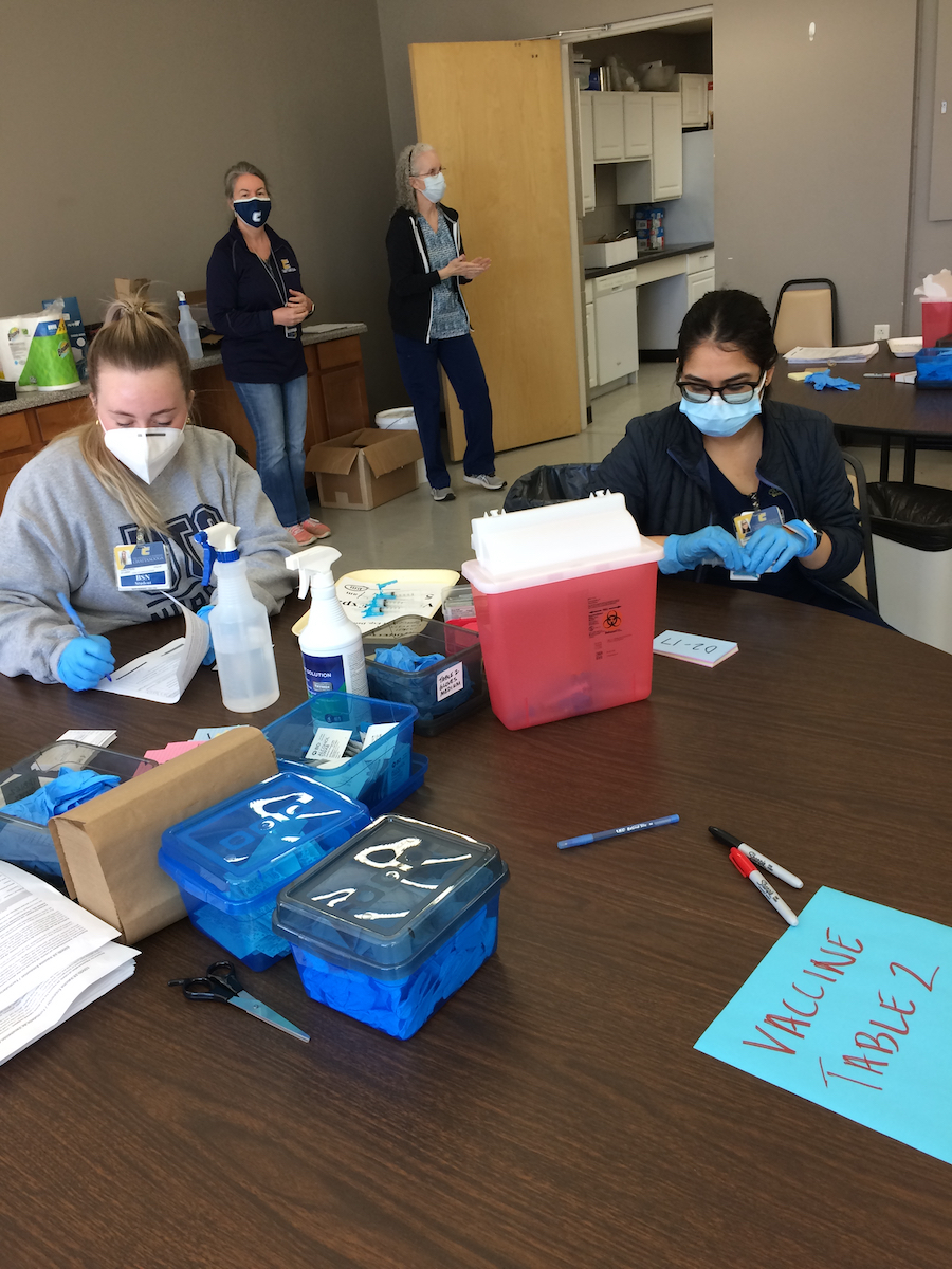 Ashley Hunter, left, and Hardi Patel in front. In back, Lecturer Connie Uffalussy and Clinical Assistant Professor Paula Jo Peters, both in the School of Nursing