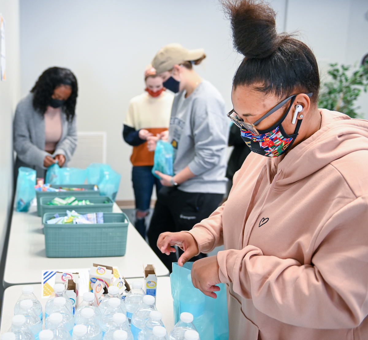 Tytana Wilson packs goodie bags for teachers and staff at local schools.