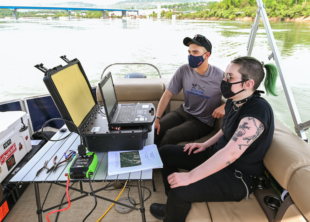 Sam Fuller and India Toth keep an eye on the sonar screen during the underwater search.