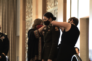 2nd Lt. Megan Hawkford’s mother and sister pin her gold bars on her shoulders.