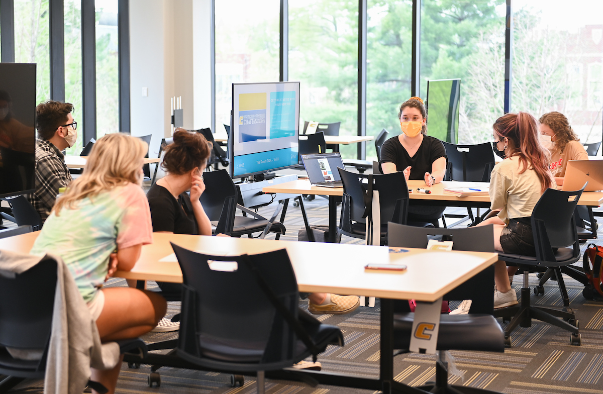 Students discuss ideas for the signs they're redesigning.
