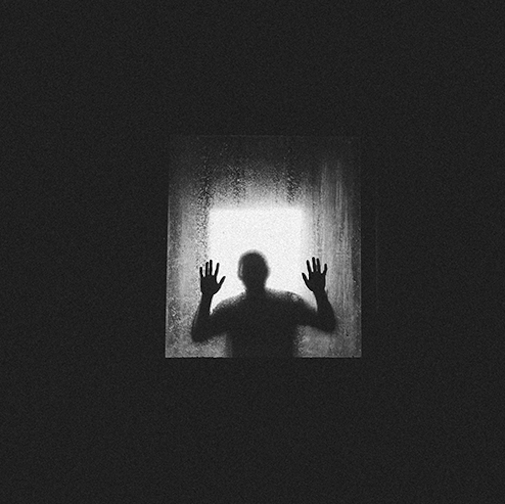 Silhouette of a person with hands pressed against a foggy window.