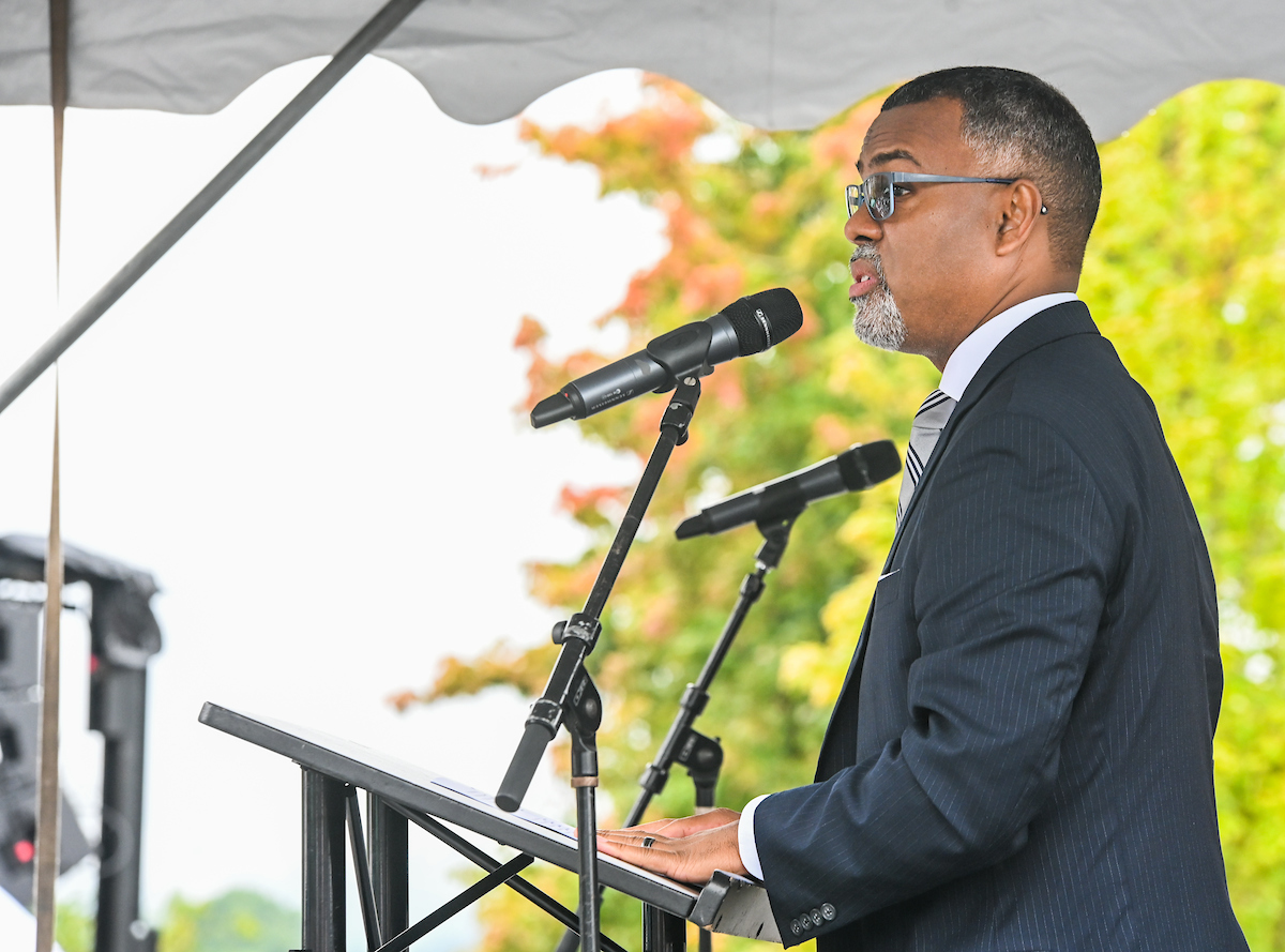 Eddie Glaude Jr. speaking at a podium with dual microphones.