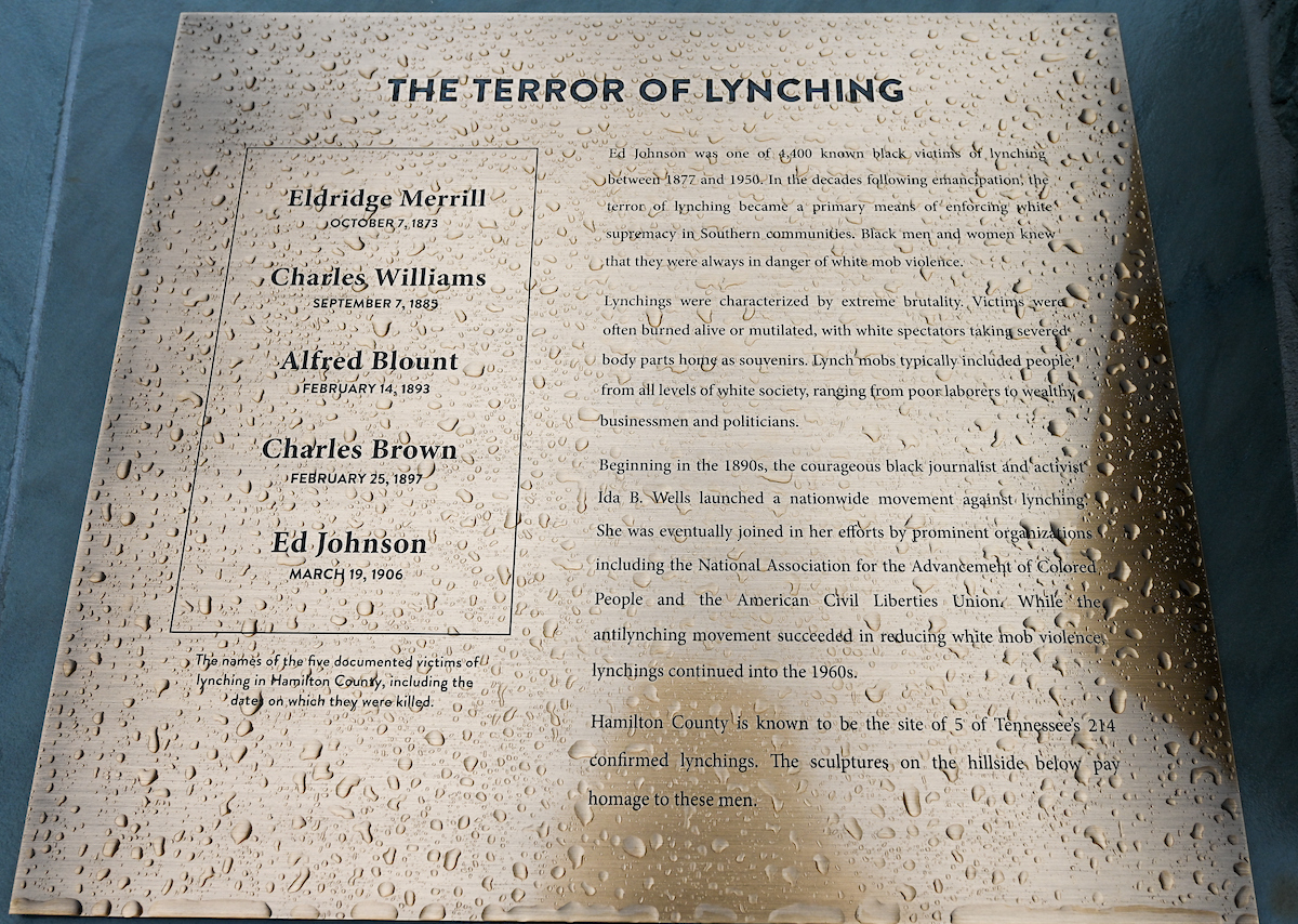 A dripping plaque at the Walnut Street Bridge describes the history and horrors of lynchings.