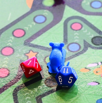 Vibrant dice on a dotted game board.