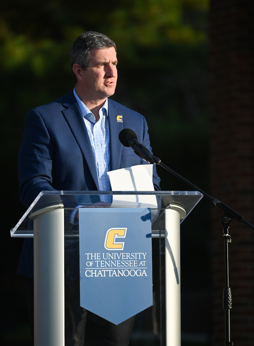 Chattanooga Mayor Tim Kelley speaking at a podium in an outside setting.