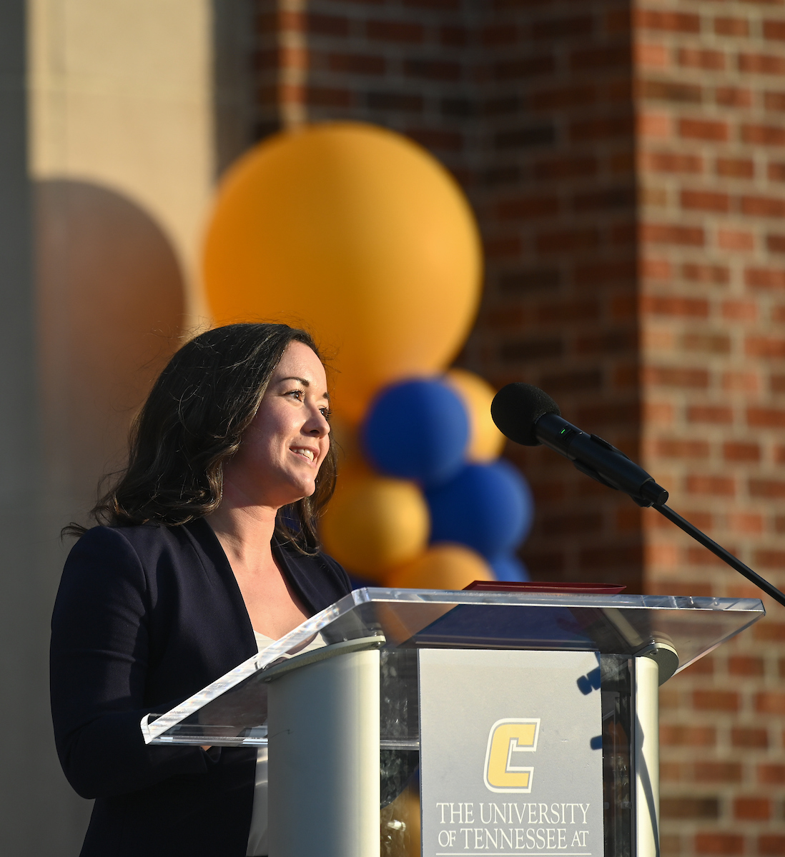 Julia Bursch speaking at a UTC-branded podium.