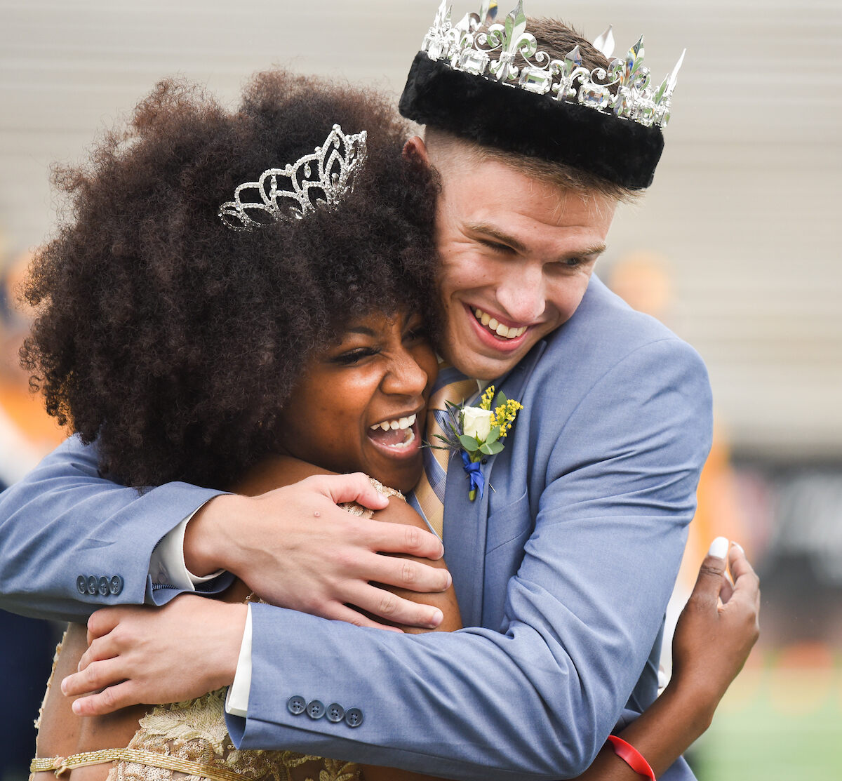 Homecoming King and Queen, Allen Towry and Aali Yarbrough, hug tightly while smiling.