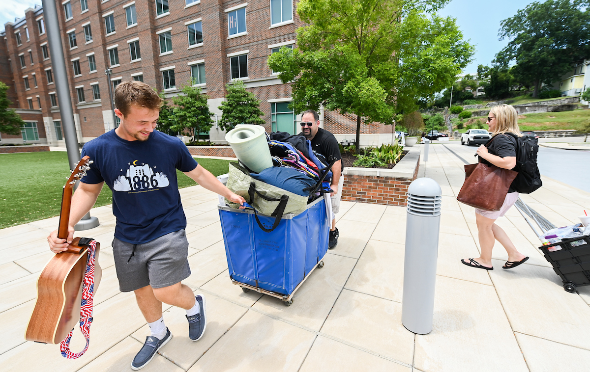 A family helps their son move into West Campus Housing during Operation Move In on Thursday, Aug. 12.
