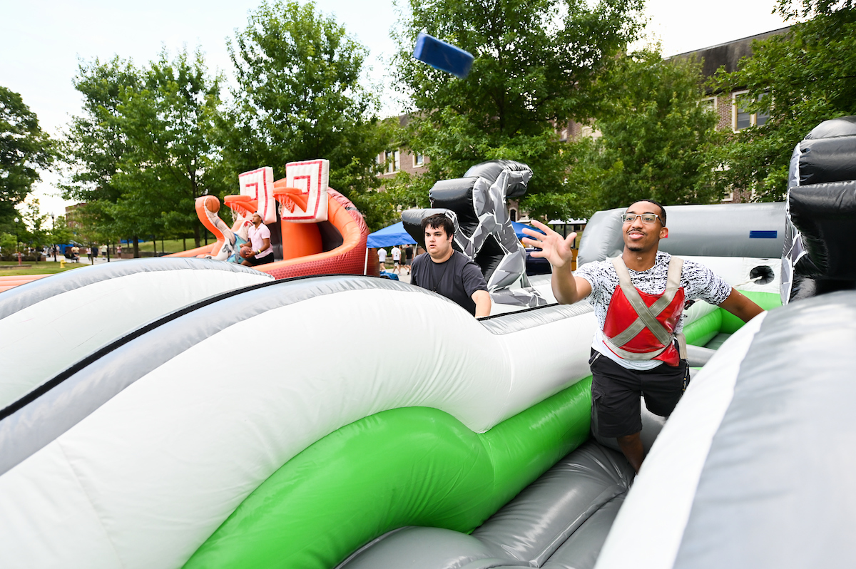 Chris Bogans, right, play games during the Oak Street Roast on Sunday, Aug. 15, on Chamberlain Field.