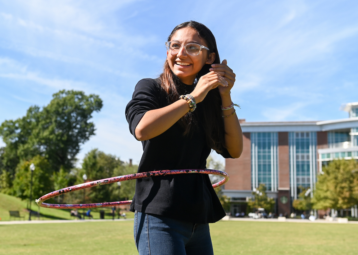 A student hula hoops during the Big Fall Kickoff on Chamberlain Field.