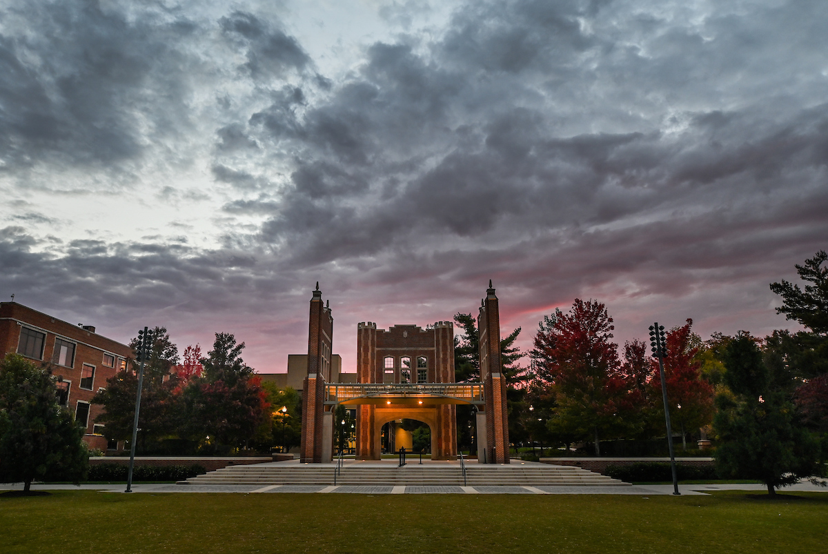 The sun rises behind Chamberlain Pavilion.