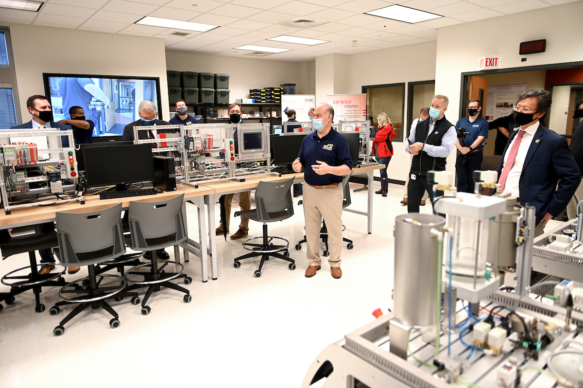 Head of the Department of Engineering Management and Technology Ahad Nasab, center, introduces the new Mechatronics Lab during its grand opening in the College of Engineering and Computer Science building.