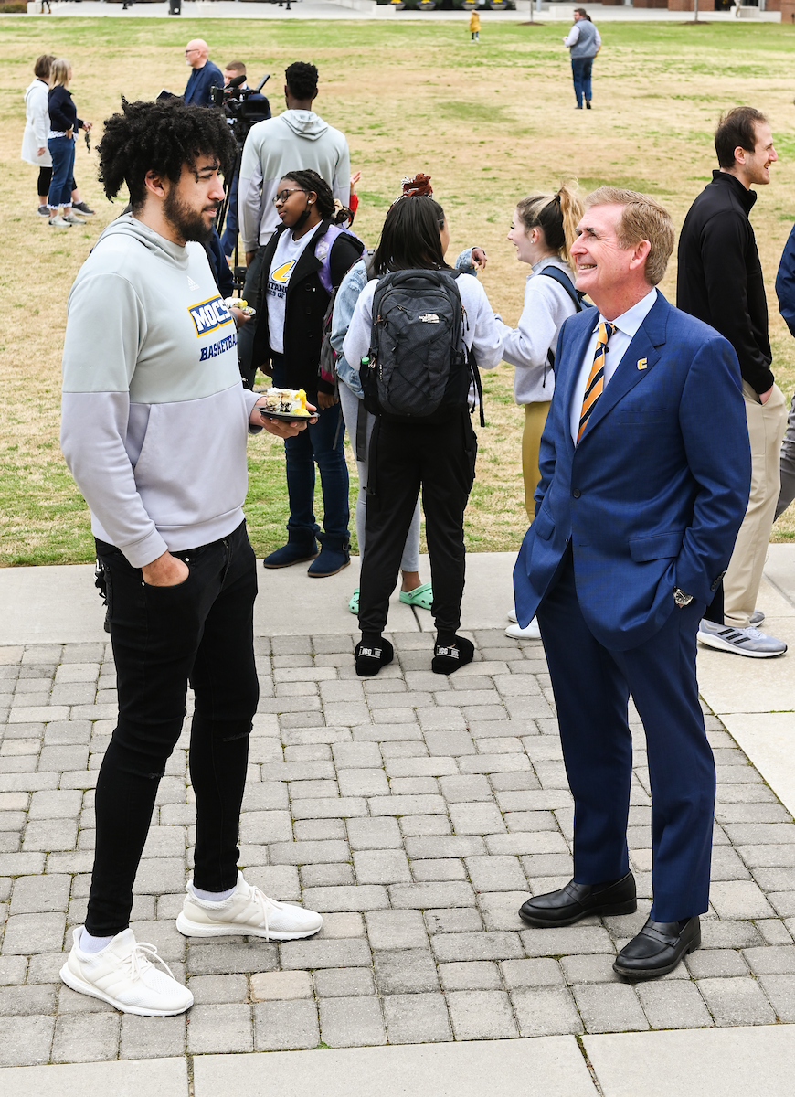 UTC Chancellor Steve Angle chats with center Avery Diggs.