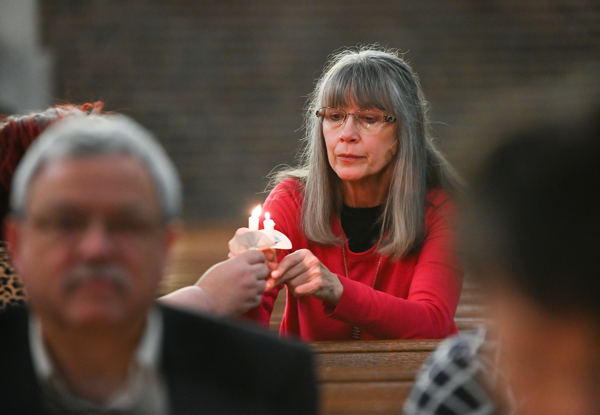 Attendees are given candles to hold during the Blue and Gold Memorial Service.