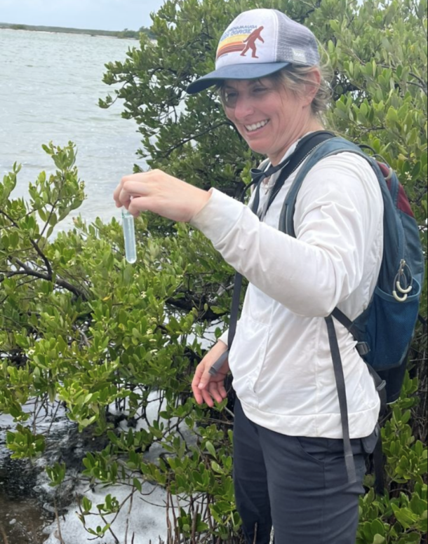 Emory Evans collects water samples.