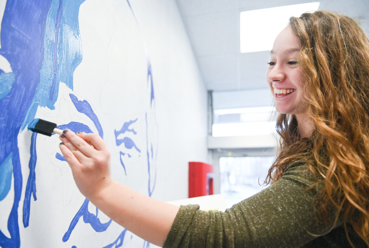 Madison Myers works on a mural in Davenport Hall Thursday, Jan. 23, 2020.