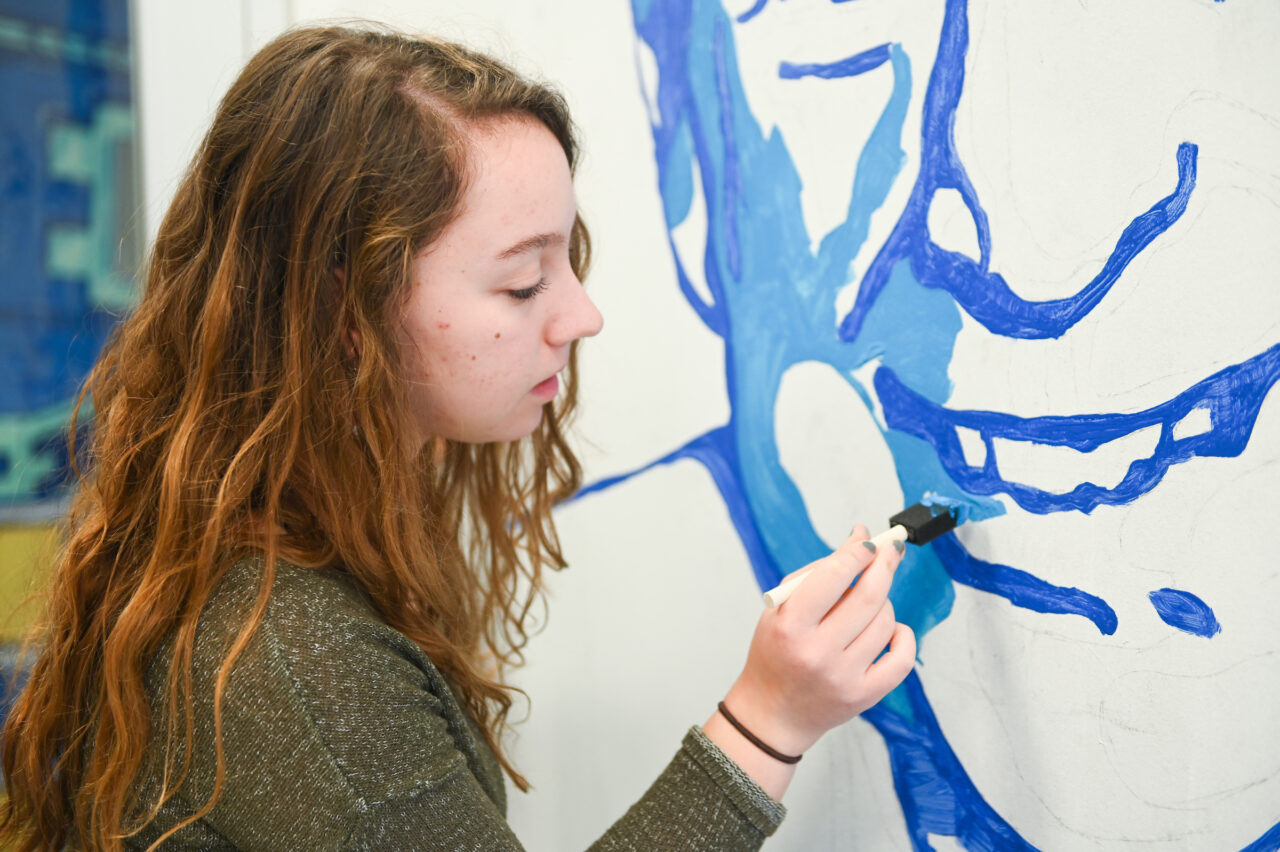 Madison Myers works on a mural in Davenport Hall Thursday, Jan. 23, 2020.