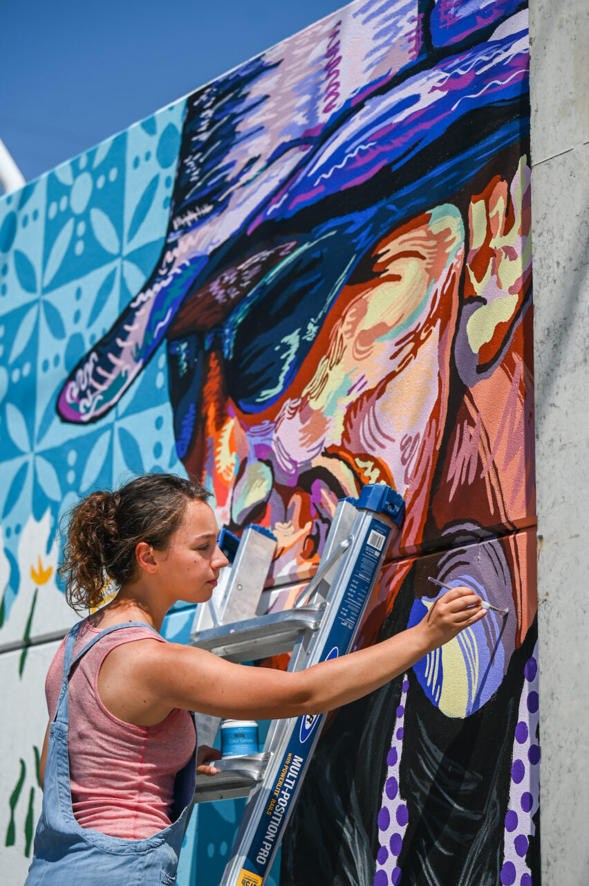 Madison Myers works Wednesday, April 27, 2022 on her mural at the EPB building near MLK Blvd.