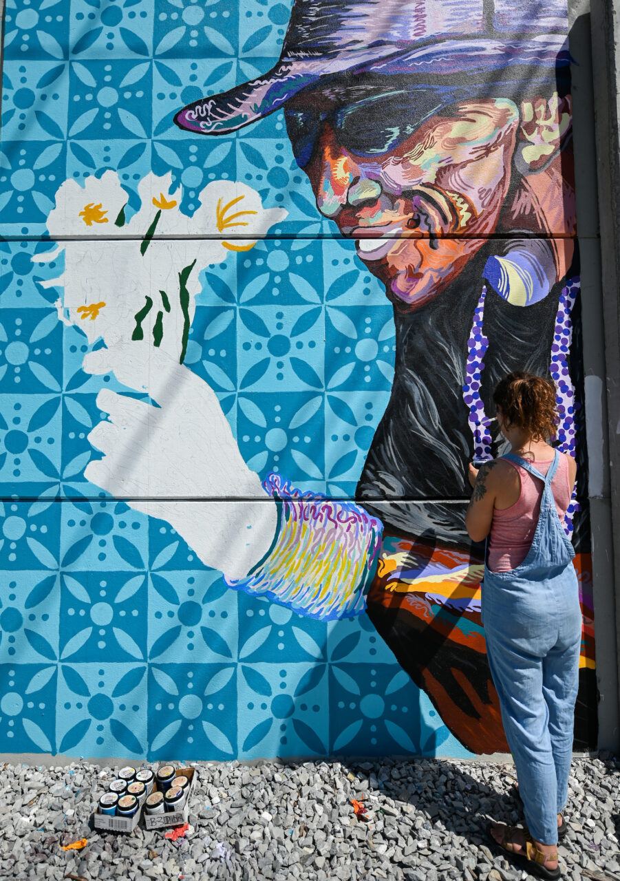 Madison Myers works Wednesday, April 27, 2022 on her mural at the EPB building near MLK Blvd.