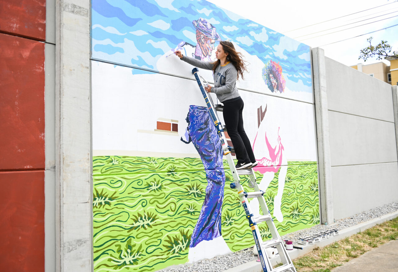Madison Myers works on her mural Wednesday, April 21, 2021 on 10th Street.