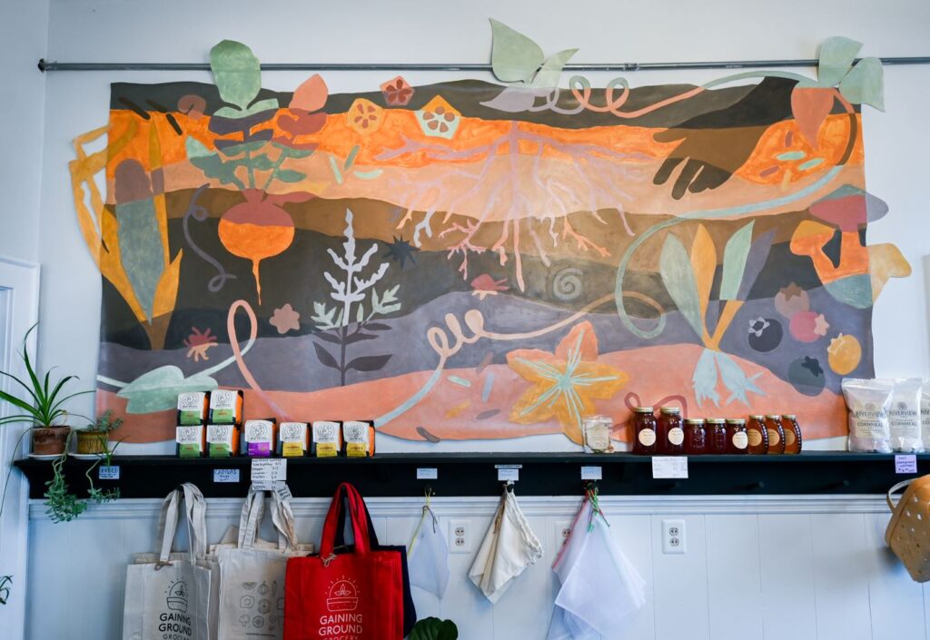 Amanda Brazier’s mural for Gaining Ground Grocery, and the process of how she essentially turned dirt into pigments for the mural’s earthy palette, were captured in Jerrod Niles’ award-winning storytelling project.