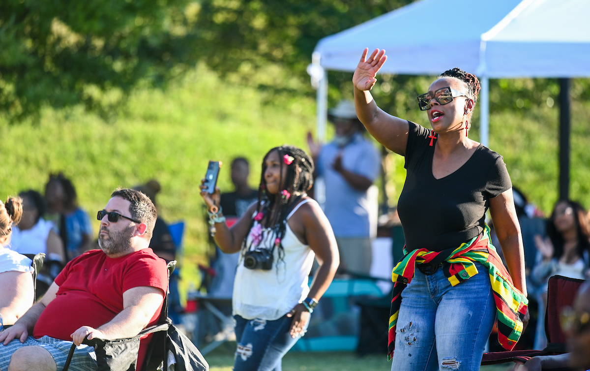 Audience members sing and dance during the Juneteenth celebration on Chamberlain Field.