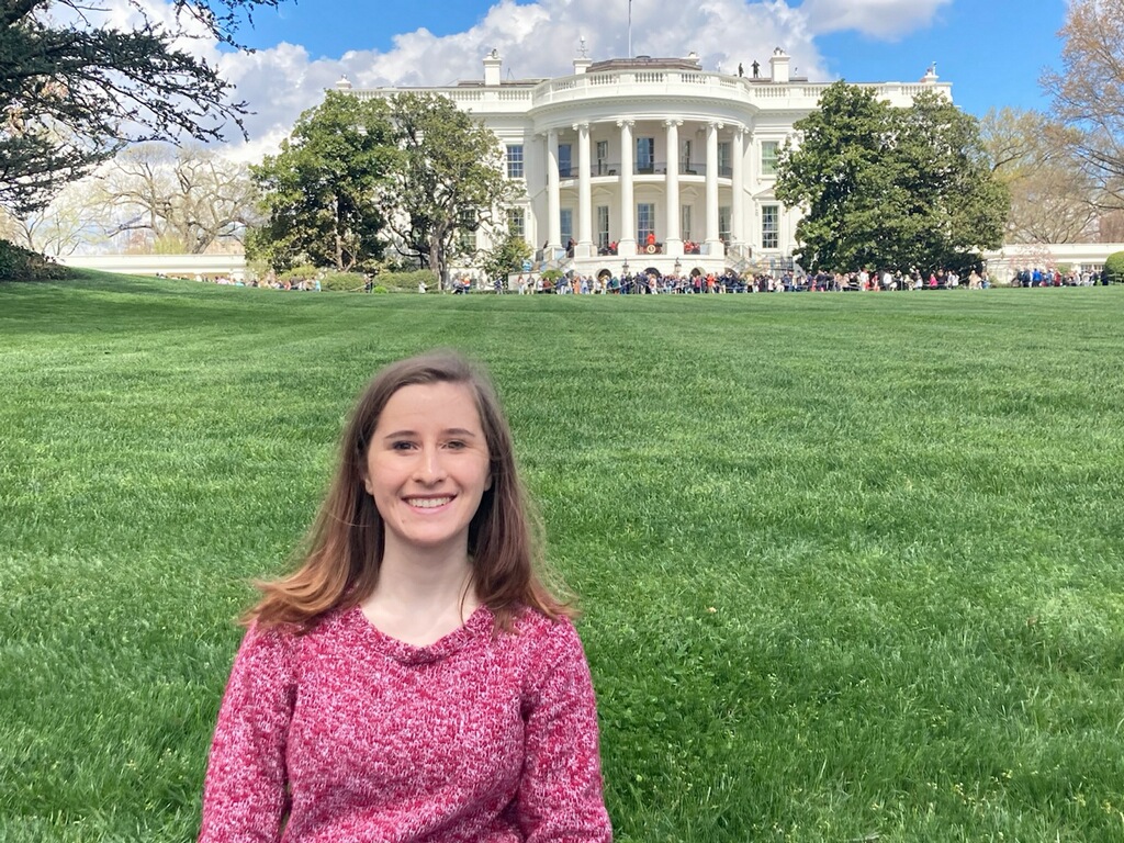 December 2021 graduate Nicki Messer, now a congressional staff assistant, stands in front of the White House