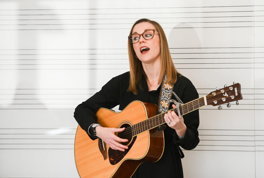 Katherine Goforth Elverd, shown singing and playing the guitar, has been the director of music therapy at the University of Tennessee at Chattanooga since 2019. Photo by Angela Foster.