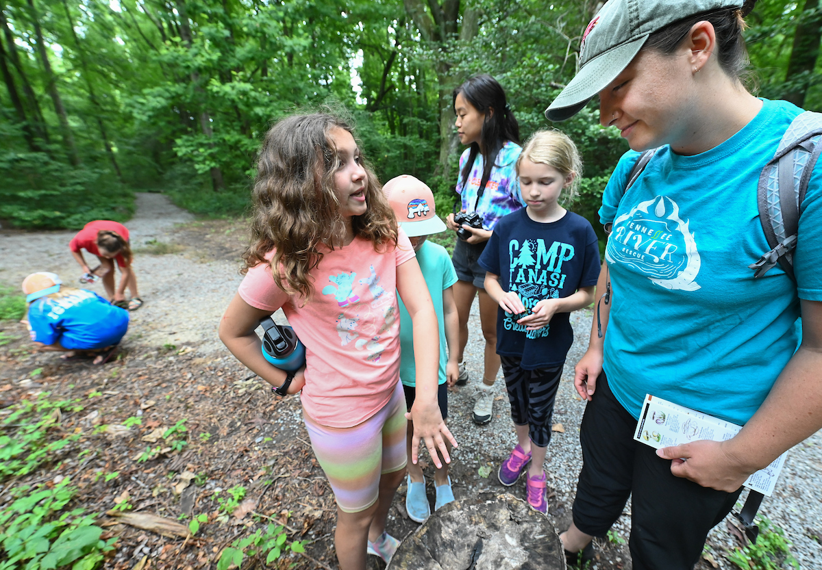 Kristen Woodall, far right, and Serretta Malaikham, center back, talk with campers at WaterWays camp.