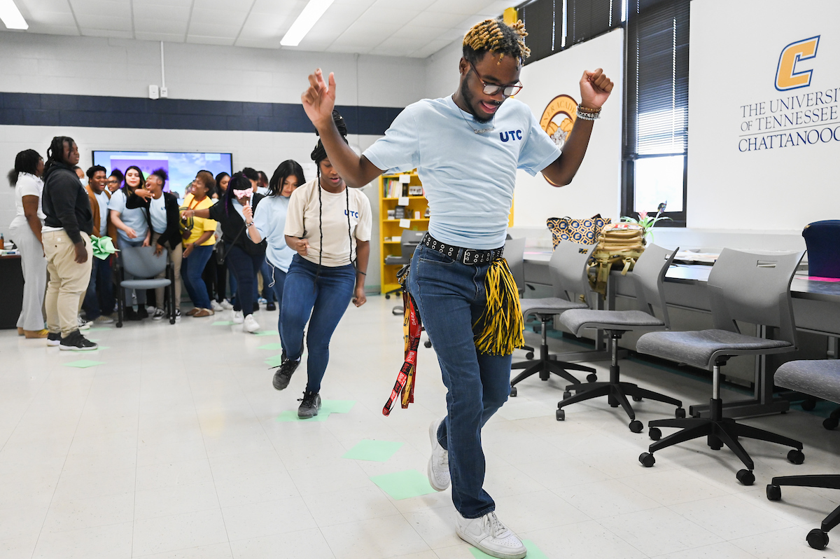 Tyner student Te'on Johnson crosses a paper stream in a team-building exercise.