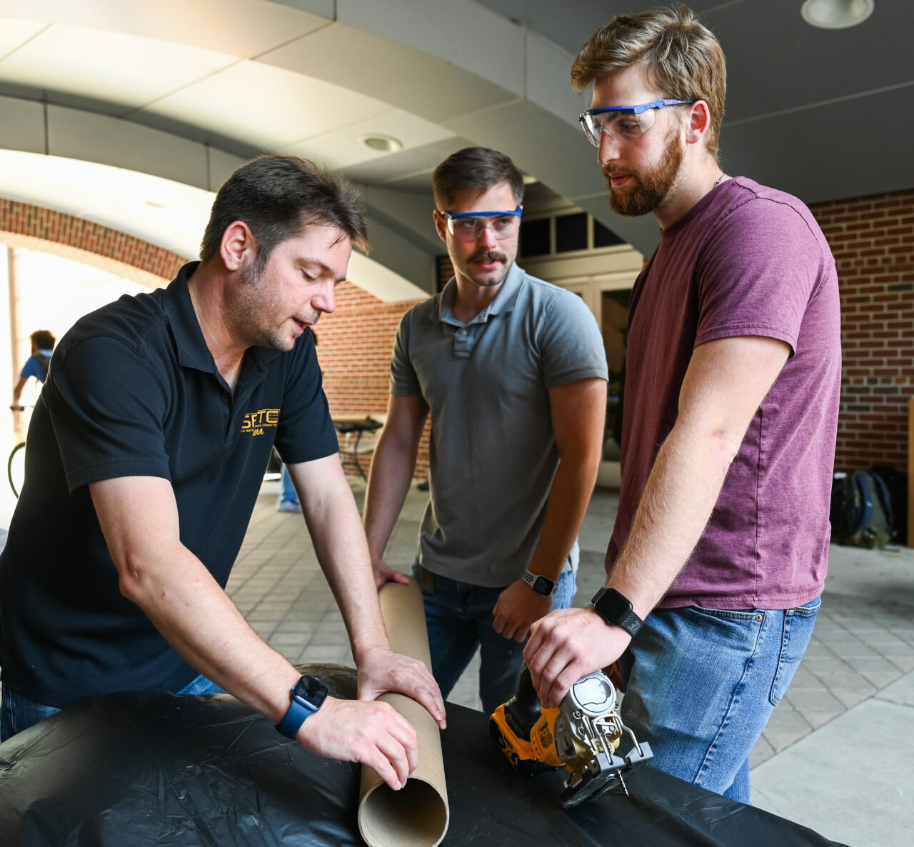 2023 NASA USLI Rocket Mocs Team members work Friday, Oct. 7, 2022 outside of the ECS building on their certification rockets in preparation for their competition.