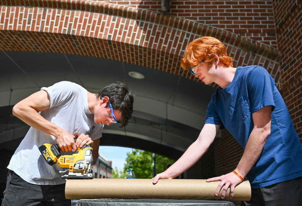 Rocket Mocs team members Mat Ormaza, left, and Elijah Schmiesing-Joyce work Friday, Oct. 7, 2022, on their certification rockets. Photo by Angela Foster.